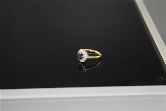 An 18ct and Plat, sapphire and illusion set diamond oval cluster ring, size M, gross weight 3.5 grams,